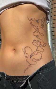 a woman's stomach with tattoos on it