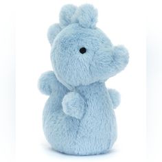 a blue teddy bear sitting on top of a white surface