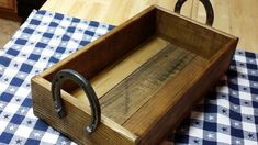 an old wooden box sitting on top of a blue and white checkered table cloth