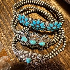 Expertly crafted with intricate detail, this Handmade Boho Navajo Turquoise Cabochon Flower Stretch Bracelet is a stunning addition to any jewelry collection. The beautiful and unique flower design, made with high-quality turquoise stones, adds a touch of natural elegance to any outfit. Gift box included for the perfect finishing touch. Three Piece Set Ships in Gift Box One Size Fits All, FAST shipping Southwestern Style Metal Jewelry As Gift, Southwestern Style Silver Beaded Bracelets For Gift, Southwestern Style Metal Jewelry For Gifts, Southwestern Silver Beaded Bracelet For Gift, Southwestern Turquoise Bracelets As Gift, Southwestern Style Metal Jewelry Gift, Gift Turquoise Metal Bracelets, Adjustable Flower Costume Jewelry, Vintage Turquoise Bracelets As Gift