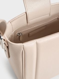 This product is made with at least 20% sustainable materials by weight. CHARLES & KEITH uses recycled, degradable, organic, and water-based materials in our eco-conscious collection. Casual with a polished air, the Petra bucket bag is a versatile companion. The light oat finish softens the bold, boxy silhouette, while its structured bottom offers ample storage space for all your daily essentials and more. With its sleek, clean lines and minimal exterior, it pairs effortlessly well with most outfits. It also comes with an adjustable strap that offers even more styling options. Minimal Exterior, Charles Keith, Daily Essentials, Sustainable Materials, Eco Conscious, Clean Lines, Storage Space, Oats, Bucket Bag