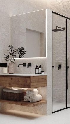 a bathroom with a sink, mirror and towel rack on the shelf next to it