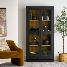 a living room filled with furniture and a book shelf next to a chair in front of a window