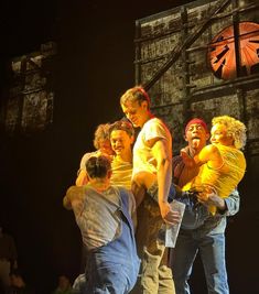 a group of men standing next to each other on a stage