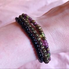 Each One Is Made With Stretchy Cord And Can Be Worn Alone Or As A Set! One Is Made With Black Beads, Another With Copper Beads With Lace-Like Cutout Designs, And The Other With Purple, Green, And Copper Colored Beads :) *A Tip To Put On A Stretchy Bracelet Is To Roll It Over Your Hand Without Stretching It To Prolong Its Life* They Are Roughly 7 Inches Each My Wrist In The Photos Measures 5 3/4’’ Let Me Know If You Have Questions! Bundle 2+ For A Private Discount! Feel Free To Make An Offer! Casual Purple Beaded Bracelets With 8mm Beads, Casual Purple Jewelry For Festival, Adjustable Purple Bracelets With Black Beads, Adjustable Purple Bracelet With Black Beads, Green Multi-strand Beaded Bracelets With Faceted Beads, Green Multi-strand Adjustable Beaded Bracelets, Cheap Purple Hand-strung Beaded Bracelets, Casual Purple Hand-strung Beaded Bracelets, Hand-strung Purple Stretch Bracelet