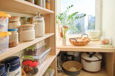 the shelves in this kitchen are filled with food