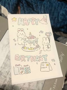 a birthday card with an image of a cake and teddy bears on it, surrounded by other greeting cards