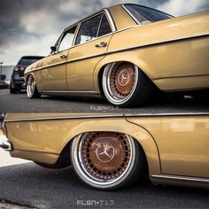 an old yellow car parked in a parking lot