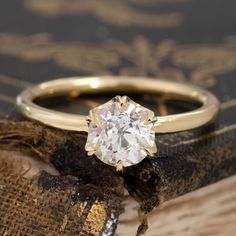 a diamond ring sitting on top of an old book