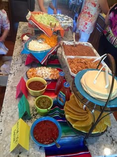 a table filled with lots of food and condiments on top of each other