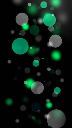 green and white circles are floating in the air on a black background with space for text