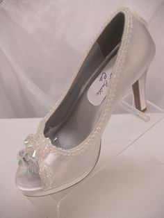 SALE THIS PAIR ONLY REG PRICE: $162.00 NOW: $138.00 READY TO SHIP SHOES USA SIZE: 5.5 (5 1/2), AS SHOWN IN PICTURE. *If you need a different color or size please see below. Beautiful Shoes for Todays Brides! : 3 1/4'' Heels Beautifully embellished with iridescent pearls edging; Shoes are peep toes with an iridescent embellishment, soooo, cute Shoes have platform to rest your feet :) the back heel of the shoe has a cute iridescent embellishment, please look at all the pictures *Need this shoe is Fitted Silver Open Toe Wedding Shoes, Silver Open Toe Fitted Wedding Shoes, Embellished Fitted Round Toe Wedding Shoes, Embellished Fitted Wedding Shoes With Closed Toe, Embellished Open Toe Wedding Shoes For Gala, Open Toe Embellished Wedding Shoes For Formal Occasions, White Open Toe Wedding Shoes For Gala, White High Heel Shoes, Modern Cinderella