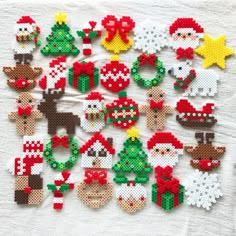 cross stitch christmas ornaments are displayed on a table