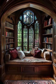 a window seat in the corner of a room with lots of bookshelves and pillows