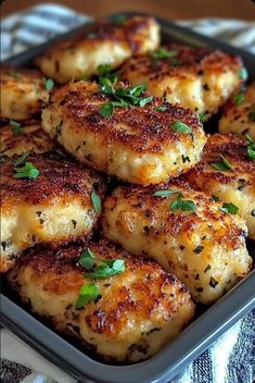 some food that is sitting in a pan on a table with a cloth and napkin