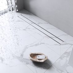 a wooden bowl sitting on top of a white floor next to a window in a room