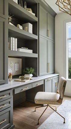 a home office with gray cabinets and gold accents