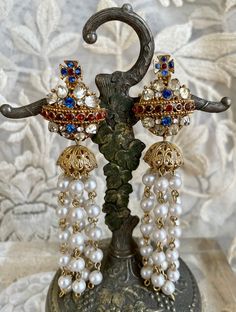 "This is a stunning pair of R. Serbin faux pearl chandelier earrings.  There are 7 pearl strands with clip backings.  The top crystal orb measures 1\" across x 1-1/4\", with strands 4\" down. Please note that one of the rhinestones are the bottom of one orb has been replaced (see photo).  Priced as is." Crystal Orb, Pearl Chandelier Earrings, Pearl Chandelier, Beaded Belt, Dress Clip, Vintage Bakelite, Pearl Strands, Blue Stone, Chandelier Earrings