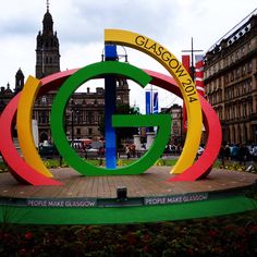 a large colorful sculpture in the middle of a plaza