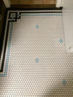 a bathroom floor with blue and white tiles