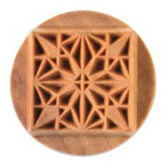 an intricately designed wooden stamp on a white background