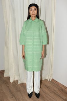 Mint cotton poplin dress with puff sleeves, side pockets, back pleated details, contrast stripe pattern and anchor thread work stitch lines.
Components: 1
Pattern: Embroidered
Type Of Work: Thread Work
Neckline: Band Collar
Sleeve Type: Puff Sleeves
Fabric: 100% Cotton Poplin
Color: Green
Other Details: 
Curved hem
Closure: Front concealed button placket
Note: The pant worn by the model is not for sale
Occasion: Work,Party - Aza Fashions Shirt Dress For Women, Embroidered Shirt Dress, Anchor Threads, Cotton Poplin Dress, Stitch Lines, Leh, Poplin Dress, Work Party, Band Collar