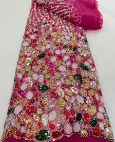 a pink dress with lots of colorful buttons on it's neck and bottom half