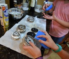 two children are making homemade pastries on a table