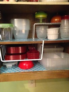 the shelves are filled with plastic dishes and bowls