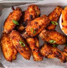 chicken wings and carrots on a tray