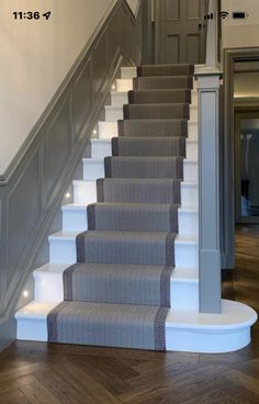 the stairs in this house have been painted gray and white with grey carpet on them