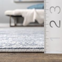 a ruler is on the floor next to a bed