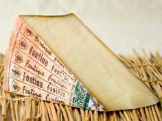 a piece of cheese sitting on top of a wicker basket