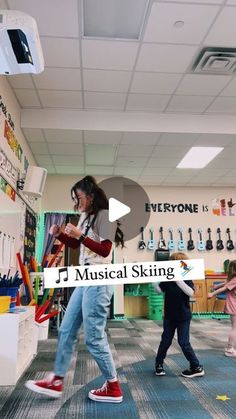 two children are playing with musical instruments in a room filled with toys and other items