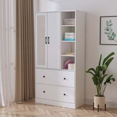 a white cabinet sitting next to a plant in a room with wooden floors and curtains