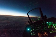 the view from an airplane at night with lights in the cockpit and on the wing