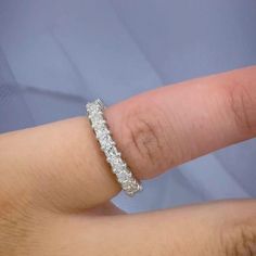 a woman's hand with a wedding ring on it