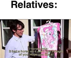 a man standing next to a pink bag with a pony on it's back