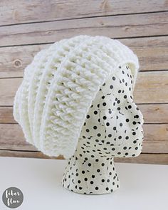 a white knitted hat with black dots on it