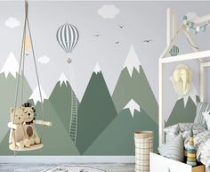 a child's bedroom with mountains and hot air balloons painted on the wall