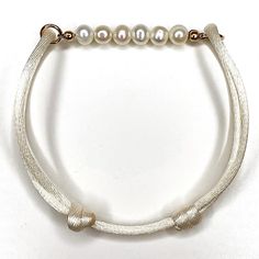 4/5mm Pearl on cream satin cord. Adjustable to fit all sizes. Elegant Adjustable Cream Pearl Bracelet, Elegant White Jewelry With Sliding Knot, Adjustable Silk Cord Jewelry With Sliding Knot, Adjustable Beige Jewelry With Sliding Knot, Elegant Adjustable Cream Bracelet, Elegant Cream Adjustable Bracelet, Elegant Adjustable Cream Jewelry, Classic Adjustable Pearl Bracelet, Elegant Adjustable Bracelet With Sliding Knot