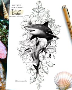 an ink drawing of a shark and flowers on a sheet of paper next to some seashells