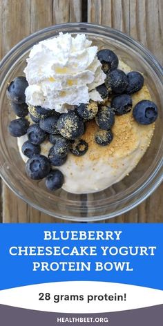 blueberry cheesecake yogurt protein bowl in a glass bowl