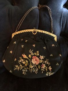 1920s beautiful black evening bag with silk flower applique: This lovely little bag is made of black silk. It features silk applique flowers front and back. The interior is cram silk. The frame is brass. It features a simple chain handle. The closure has a secure push button mechanism. It measure 7x8 in Antique Embroidered Evening Bags, Vintage Floral Embroidered Bag For Formal Occasions, Vintage Formal Bag With Floral Embroidery, Vintage Floral Embroidery Bags For Formal Occasions, Vintage Floral Embroidery Formal Bags, Black Victorian Bag For Vintage Events, Victorian Style Black Bag For Vintage Events, Victorian Embroidered Evening Bags, Black Victorian Style Bags For Formal Occasions