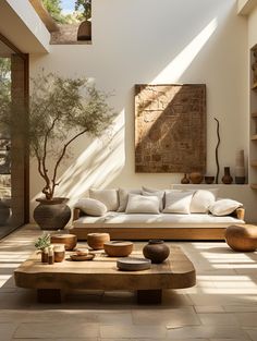 a living room filled with lots of furniture and decor on top of stone flooring