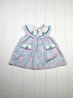 "Beautiful vintage seersucker dress! The collar detail is adorable and so is the embroidered heart and sailboat design! Size: 4T Brand: Samara Fabric: 65% polyester/35% cotton Measurements: 19\" from shoulder to hem Excellent vintage condition! I see no flaws in this piece! Please note that all listings are vintage and therefore are preowned. General wear is not noted in listings. I do try hard to thoroughly inspect each piece and I wash all pieces that are appropriate. Small flaws are part of t Playful Short Sleeve Gingham Dress, Playful Gingham Dress With Short Sleeves, Cute Gingham Seersucker Dresses, Plaid Cotton Dress For Playtime, Preppy Cotton Dress For Playtime, Preppy Cotton Dress For Picnic, Samara Dress, Summer Dress Vintage, 4t Dress