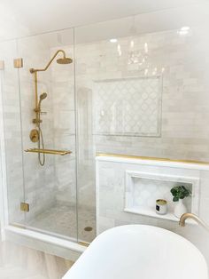 a bathroom with a bathtub, sink and shower head in it's corner