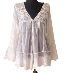 This Ibiza white women's top in size M features beautiful embroidered appliqué lace details, pleated motifs, V neckline and a tie front fastening. It's a stylish, bohemian blouse perfect for casual, wedding party or beach wear. Measurements /flat/ - shoulder to shoulder 16''/41cm armpit to armpit 17''/44cm waist 16.5''/42cm length 29''/74cm sleeves 24.5''/62cm Excellent condition. Summer Cotton Lace Blouse, Summer Cotton Lace Top Blouse, Summer Lace Top With Lace Work, White Cotton Lace Top For Summer, Summer Long Sleeve Embroidered Lace Top, Long Sleeve Embroidered Lace Top For Summer, White Crochet Lace Top For Beach Cover-up, V-neck Lace Blouse With Floral Embroidery, Crochet Lace Blouse For Vacation