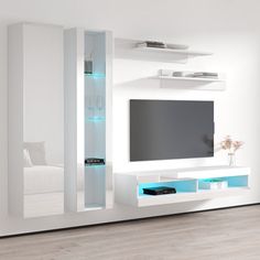 a living room with white furniture and a flat screen tv