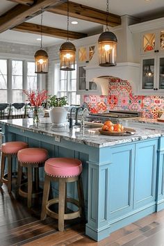 a kitchen with blue cabinets and pink stools